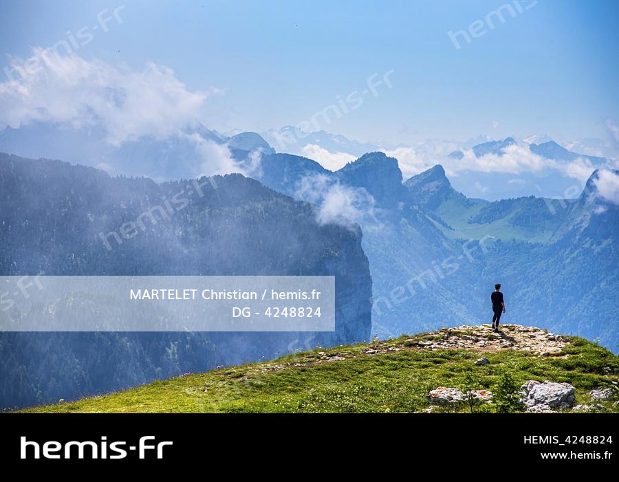 France, Haute-Savoie (74), Dingy-Saint-Clair, randonneuse contemplant le paysage sur le bord du plateau du Parmelan 